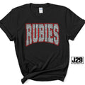 A black short-sleeve t-shirt with a graphic reading 'RUBIES' in silver glitter-style letters with a red outline, displayed on a white background with a J29 Spirit logo overlay.