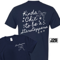 Navy blue short-sleeve t-shirt shown from both front and back on a white background. The back features white script text reading 'Kinda Chic to be a Warrior' with stars and a bow graphic.