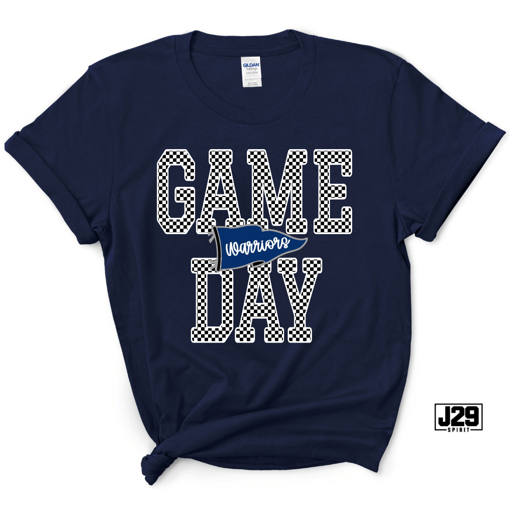 A navy blue Gildan t-shirt with a 'GAME DAY Warriors' graphic on the front. The text 'GAME DAY' is styled in a white and black checkered pattern, and 'Warriors' is written on a small blue pennant banner in the center.