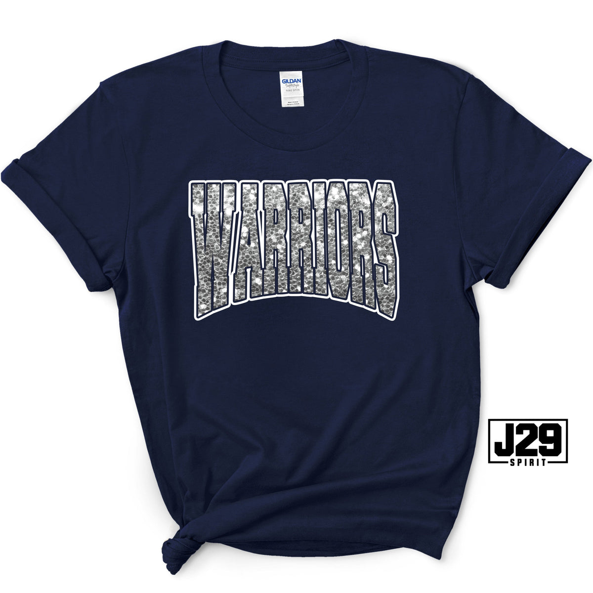 A navy blue short-sleeve t-shirt with a white graphic reading 'WARRIOR' filled with a detailed map design. The shirt is styled with a knot at the bottom hem and features a 'J29 Spirit' logo overlay in the bottom right corner.